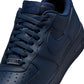 Men's Nike Air Force 1 '07 Obsidian sneakers with white midsole and navy blue upper, shown on a plain background.