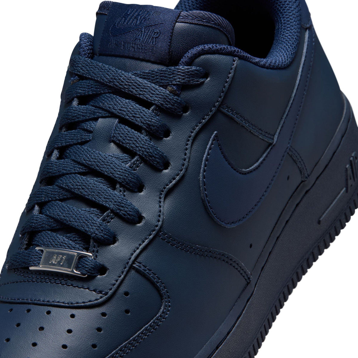 Men's Nike Air Force 1 '07 Obsidian sneakers with white midsole and navy blue upper, shown on a plain background.