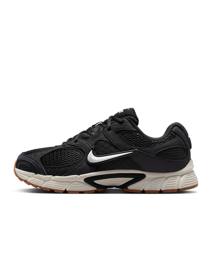 Nike men's V5 RNR black and gum color footwear, showcasing sleek design and comfortable fit in a natural outdoor setting.