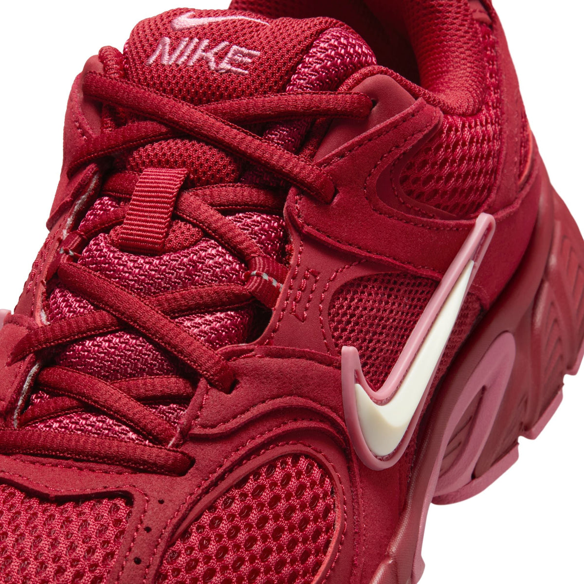 Nike women’s V5 Runner sneakers in team crimson, side view with white sole and logo detail