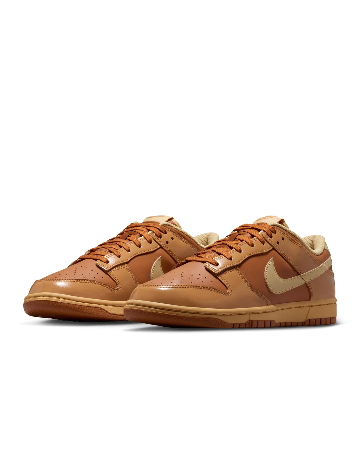 Nike Mens Dunk Low Retro Sesame sneakers in navy and tan leather, featuring classic low-top design and white midsole.