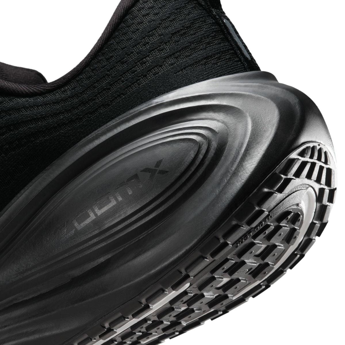 Nike men's Vomero Plus black sneakers from Denim Exchange, side view.