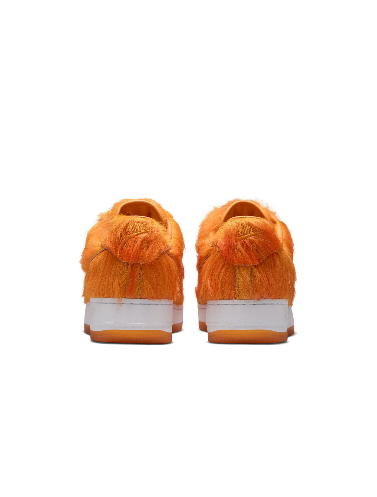 Nike men's Air Force 1 sneakers with orange pony hair accents, showcasing stylish men's footwear with textured leather details.