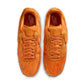 Nike Men's Air Force 1 sneakers in orange pony hair with white soles, showcasing stylish men's footwear.
