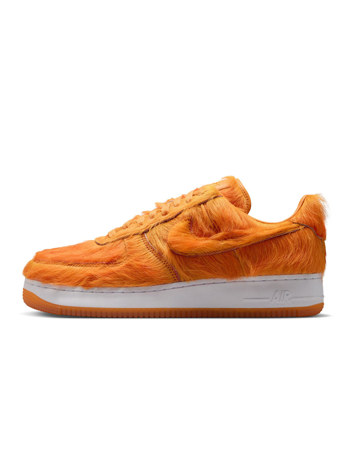 Nike men's Air Force 1 sneakers with orange pony hair accents, showcasing stylish men's footwear with bold color and textured material.