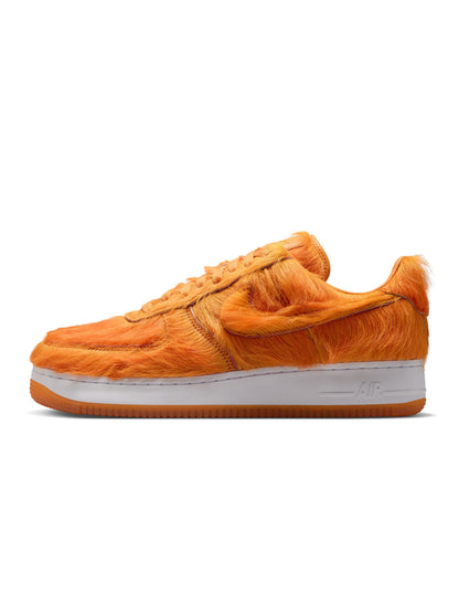 Nike men's Air Force 1 sneakers with orange pony hair accents, showcasing stylish men's footwear with bold color and textured material.