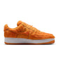 Nike men's Air Force 1 sneakers in orange pony hair with white soles, showcasing a stylish and bold footwear design.