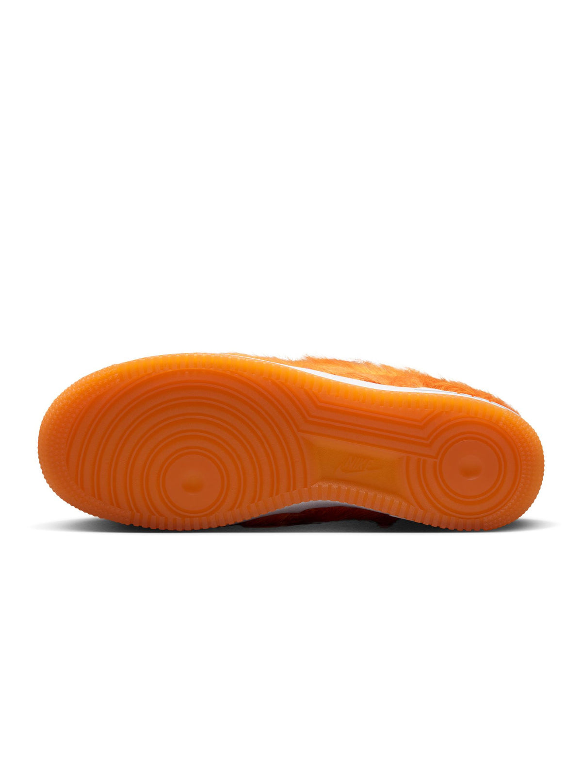 Nike men's Air Force 1 sneakers in orange pony hair, showcasing stylish footwear with a sleek design and textured upper.