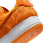 Nike men's Air Force 1 sneakers in orange pony hair, featuring a classic low-top design and white sole.