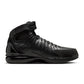 Black Nike Air Zoom Huarache 2K4 OT men's footwear shown on a model, featuring sleek design and athletic style.