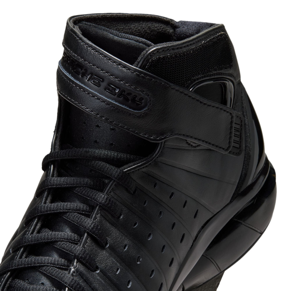 Nike Men's Air Zoom Huarache 2K4 OT black athletic shoes with mesh and synthetic overlays, designed for basketball performance.