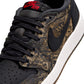 Grade school Air Jordan 1 Retro Low OG Laser sneakers in black and red, featuring Nike swoosh and low-top design.