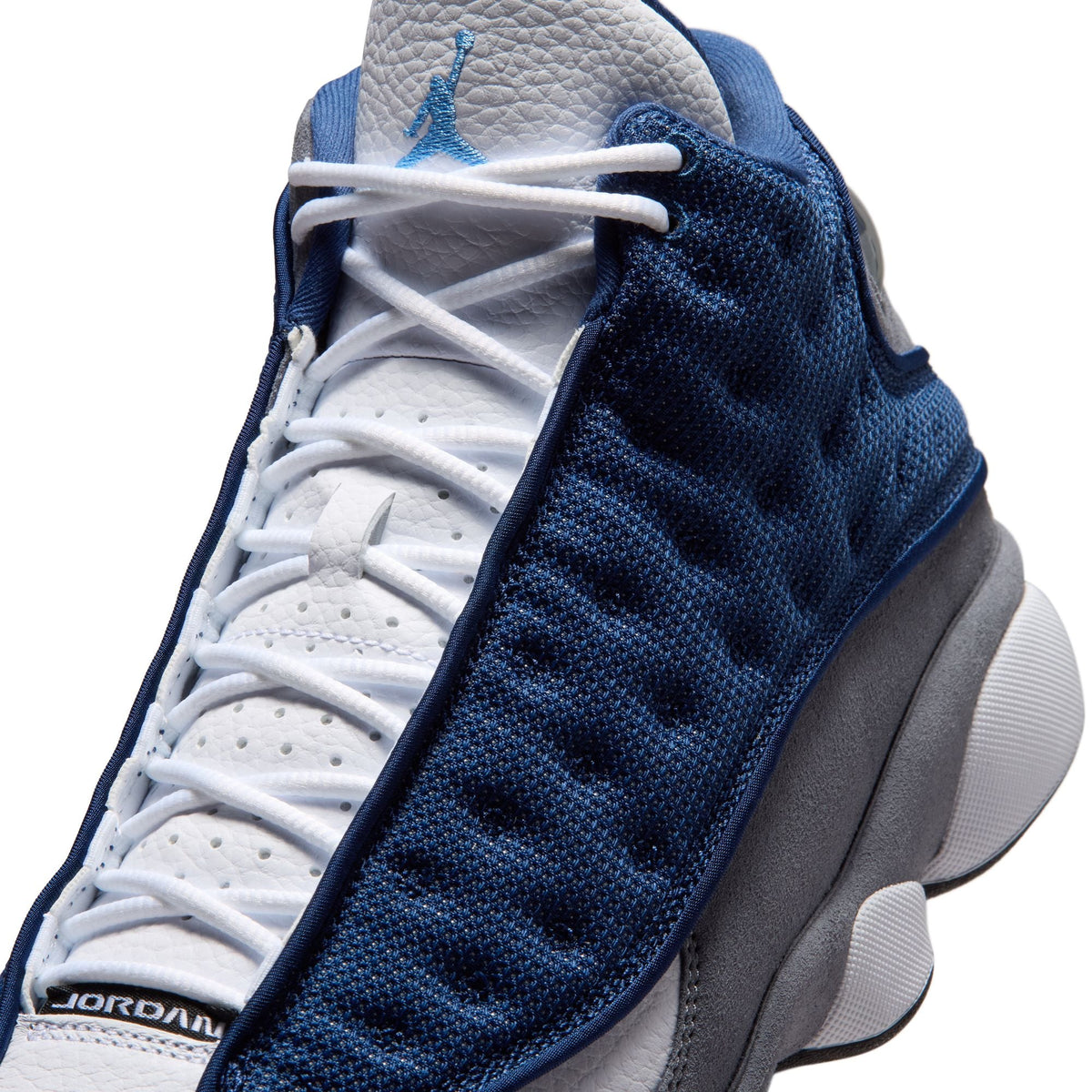 Men's Air Jordan 13 Retro Flint sneakers in navy and grey, featuring signature design details and a sleek basketball shoe profile.