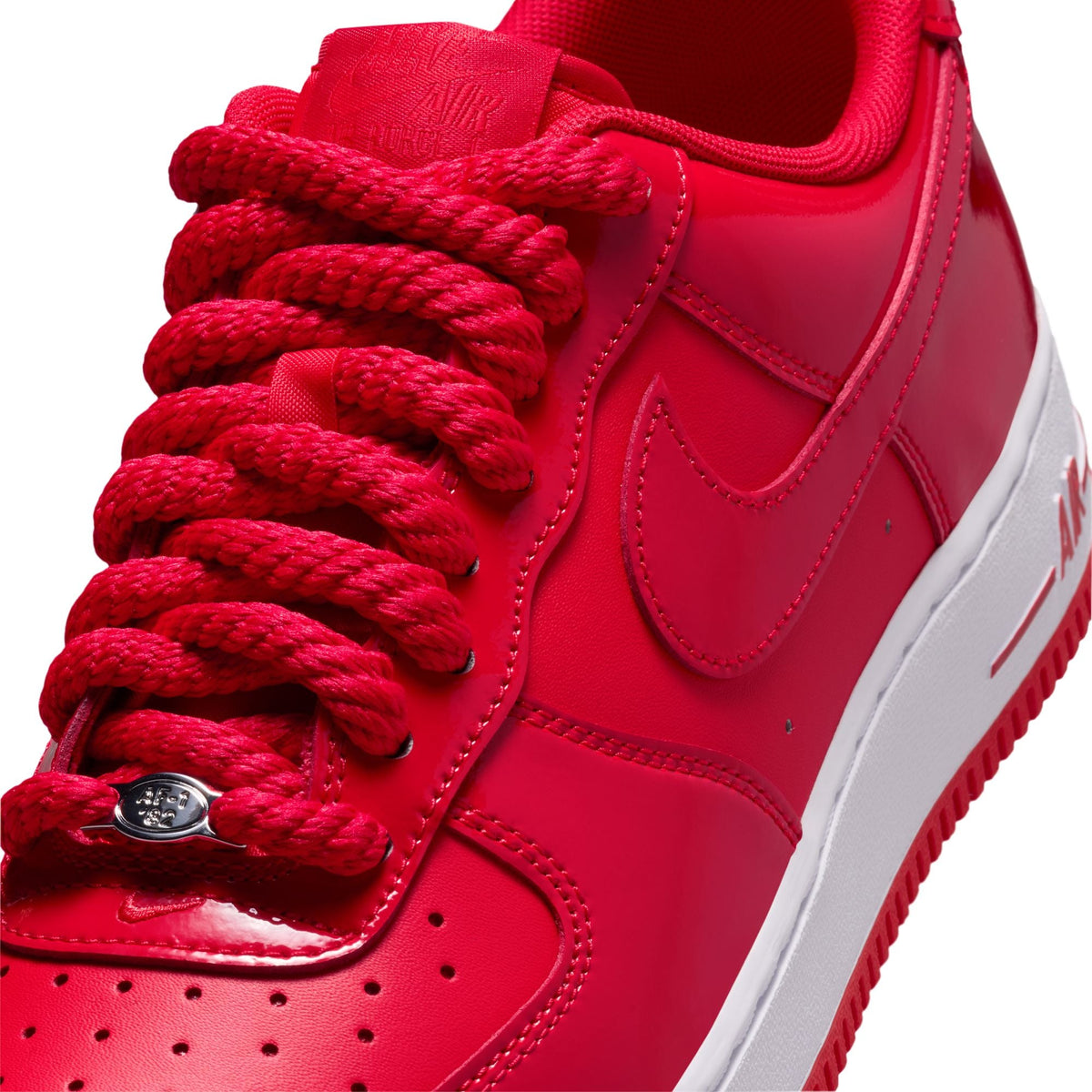 Nike Air Force 1 '07 LV8 Patent men's footwear in University Red, featuring shiny patent leather and classic sneaker design.