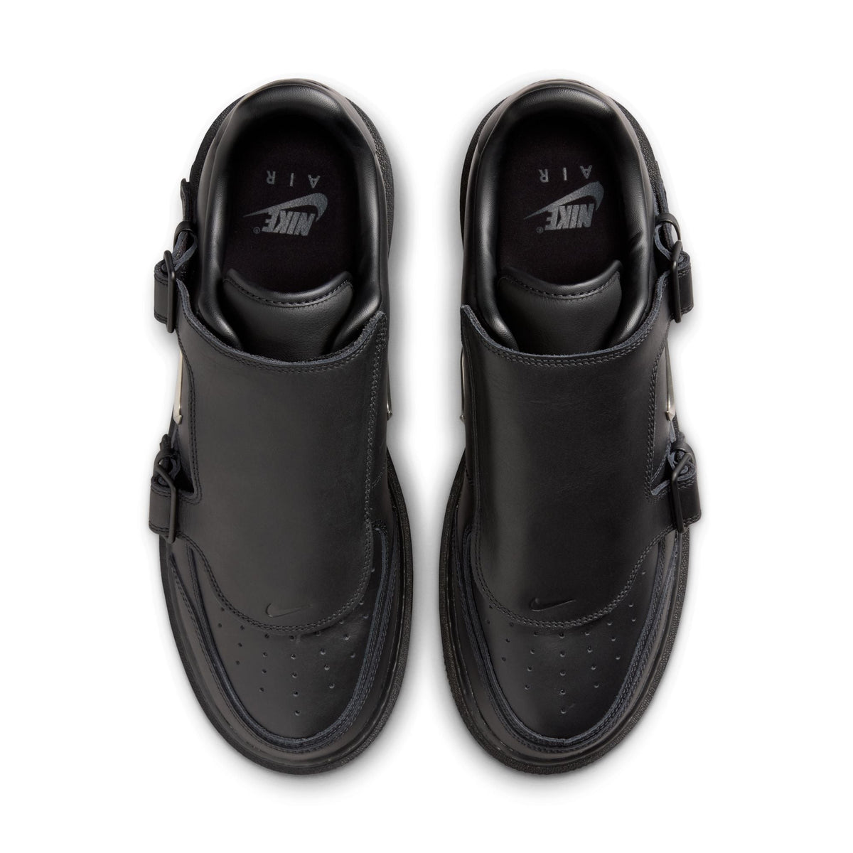 Black Nike Air Force 1 Luxe men's footwear with white soles and sleek design, showcased in a well-lit retail display.