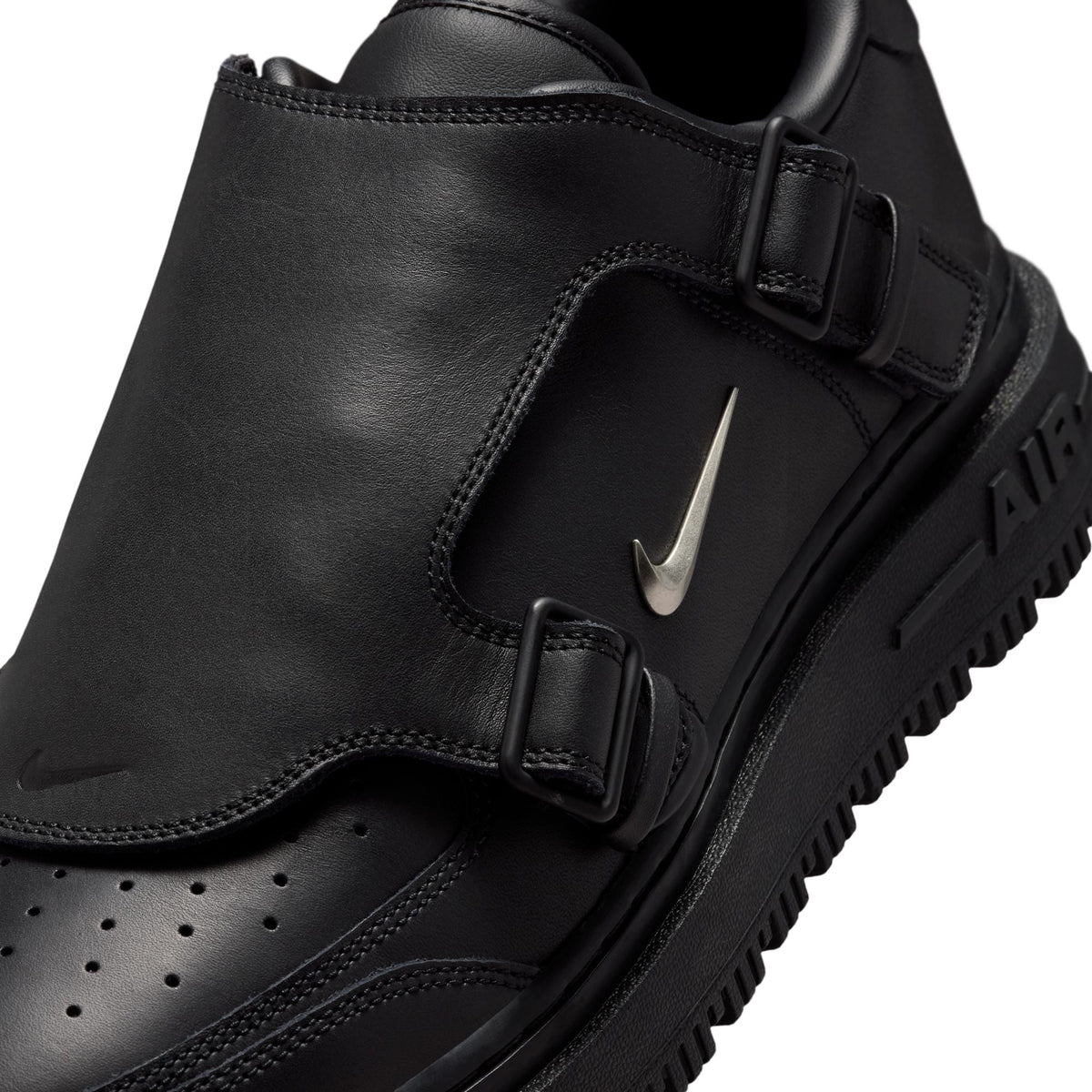 Black Nike Air Force 1 Luxe men's footwear with sleek design and premium materials, displayed on a neutral background.