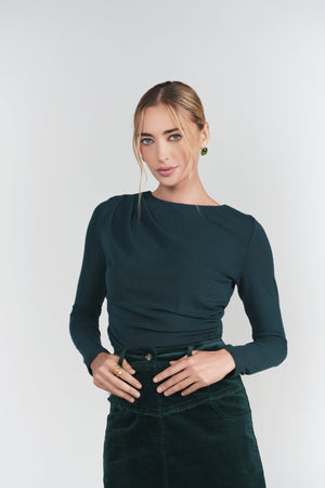 Emerald Mickie Top by Adina Las Vegas featuring a stylish, fitted design with long sleeves and elegant details.