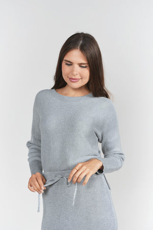 Gray sweater rib top by Adina Las Vegas, close-up of soft knit fabric and ribbed texture on the stylish women's sweater.