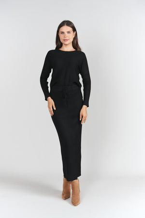 Black ribbed sweater skirt by Adina Las Vegas featuring a fitted design and knee-length style.