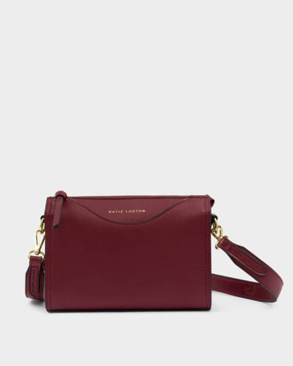 KADOU BOUTIQUE Alba crossbody bag in cherry red with adjustable strap and sleek design, perfect for casual or evening wear.