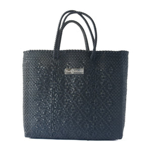 All-black large woven crossbody bag by Tin Marin Brand, showing the spacious design and textured woven material.