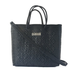 All black large woven crossbody bag by Tin Marin Brand with adjustable strap and textured woven design.