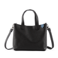 Black Emma leather small crossbody bag by Tin Marin Brand, featuring a sleek design and adjustable strap.