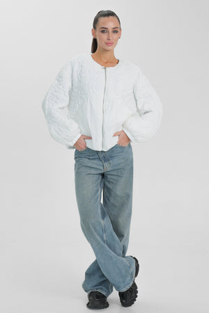 Light quilted white demi-season jacket by Alaska® Outerwear Company, displayed on a hanger with visible stitching and collar detail.