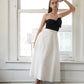 Black Flying Tomato Blissful Breeze woven midi dress displayed on a hanger with a relaxed fit and intricate woven details.