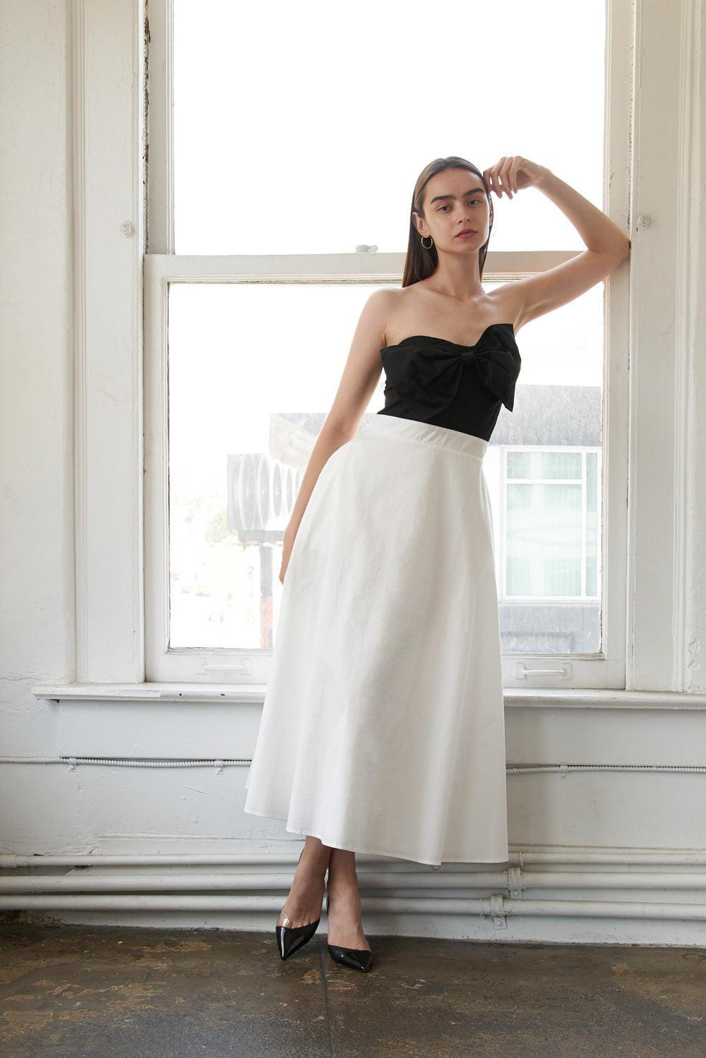Black Flying Tomato Blissful Breeze woven midi dress displayed on a hanger with a relaxed fit and intricate woven details.