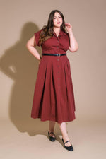 Flying Tomato Perfect Balance Woven Midi Dress in berry color, showing a stylish, knee-length dress with a fitted waist and woven fabric.