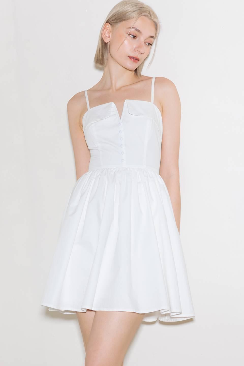 White Flying Tomato Pure Romance woven mini dress displayed on a hanger, showcasing its lightweight fabric and stylish design.