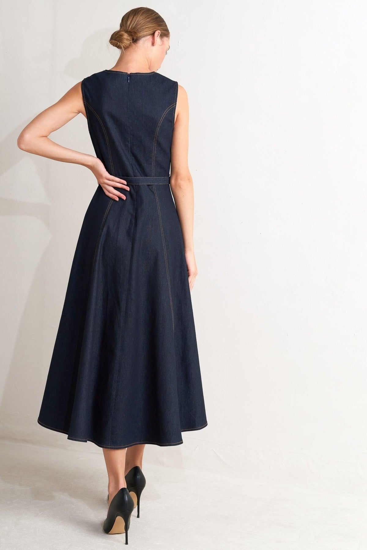 Flying Tomato modern dark denim midi dress with sleeveless design and fitted waist, styled with a round neckline.