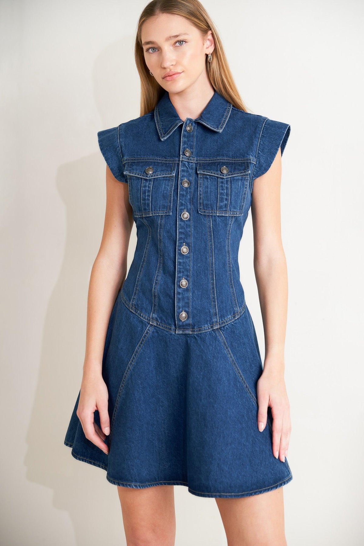 Flying Tomato blue crush denim mini dress with long sleeves and a fitted silhouette, styled with casual accessories.