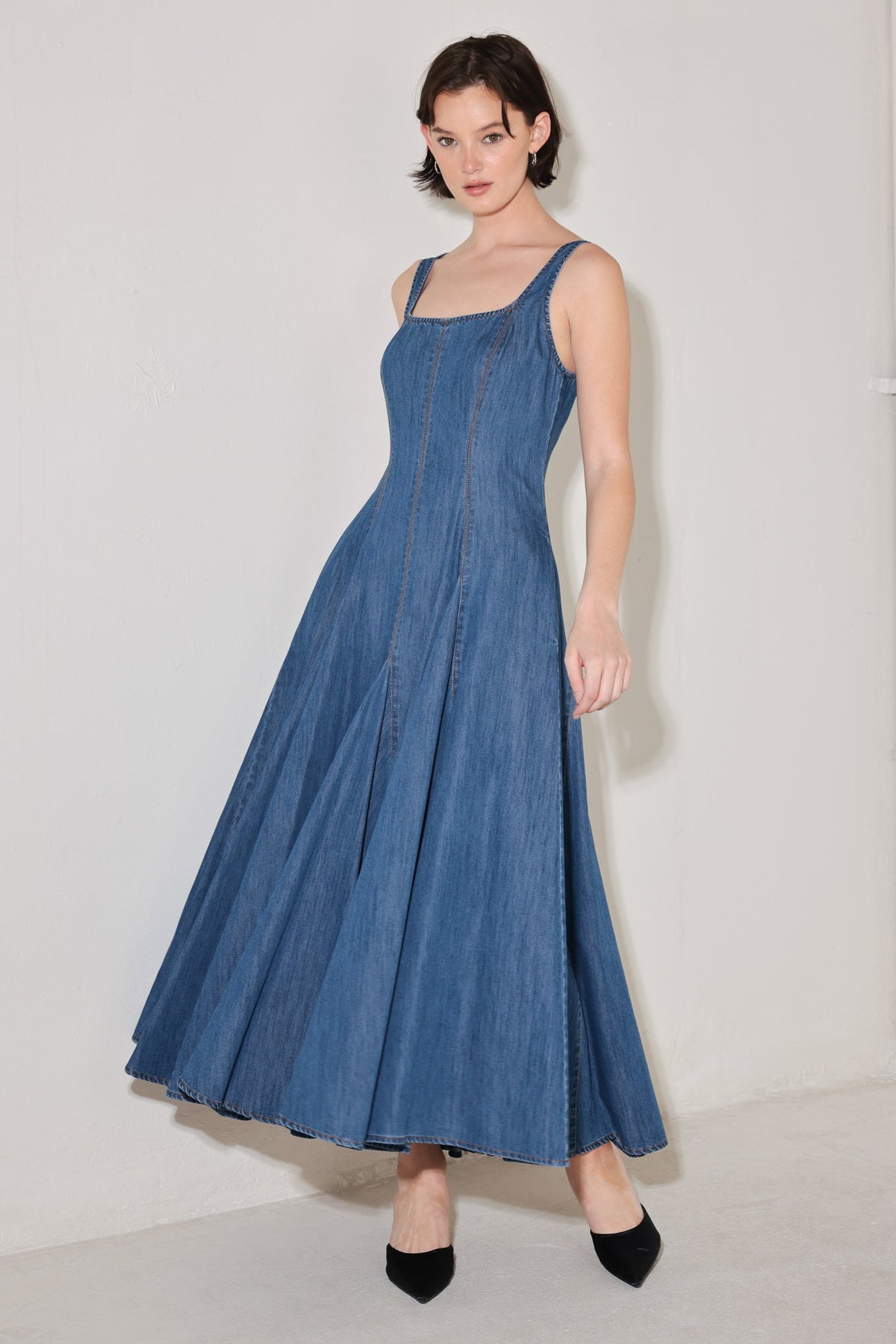 Flying Tomato Indigo Sway Denim Midi Dress with adjustable straps and side pockets, displayed on a hanger.