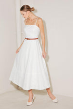 White Flying Tomato Delicate Icon Woven Midi Dress displayed on a hanger with intricate woven fabric and flowing silhouette.