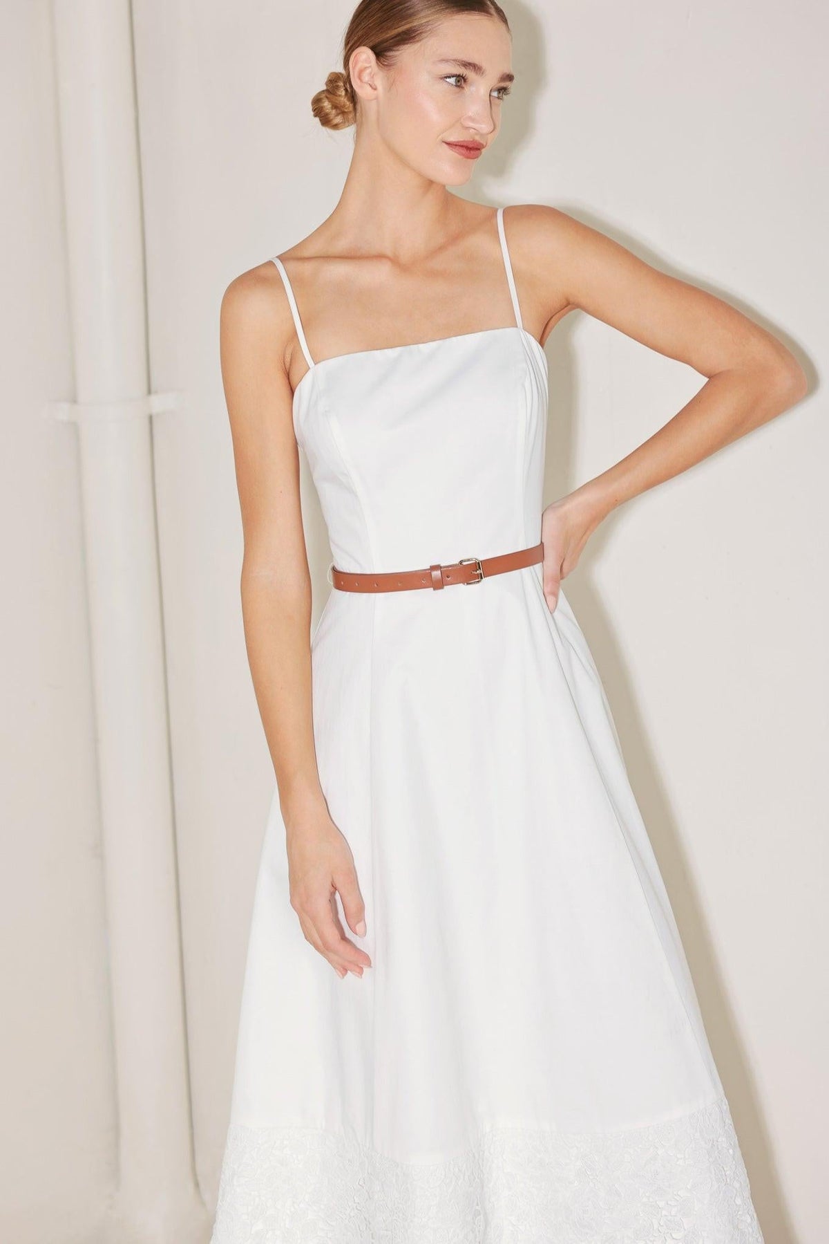 White Flying Tomato Delicate Icon Woven Midi Dress hanging on a mannequin, showcasing its lightweight, elegant design and delicate fabric.