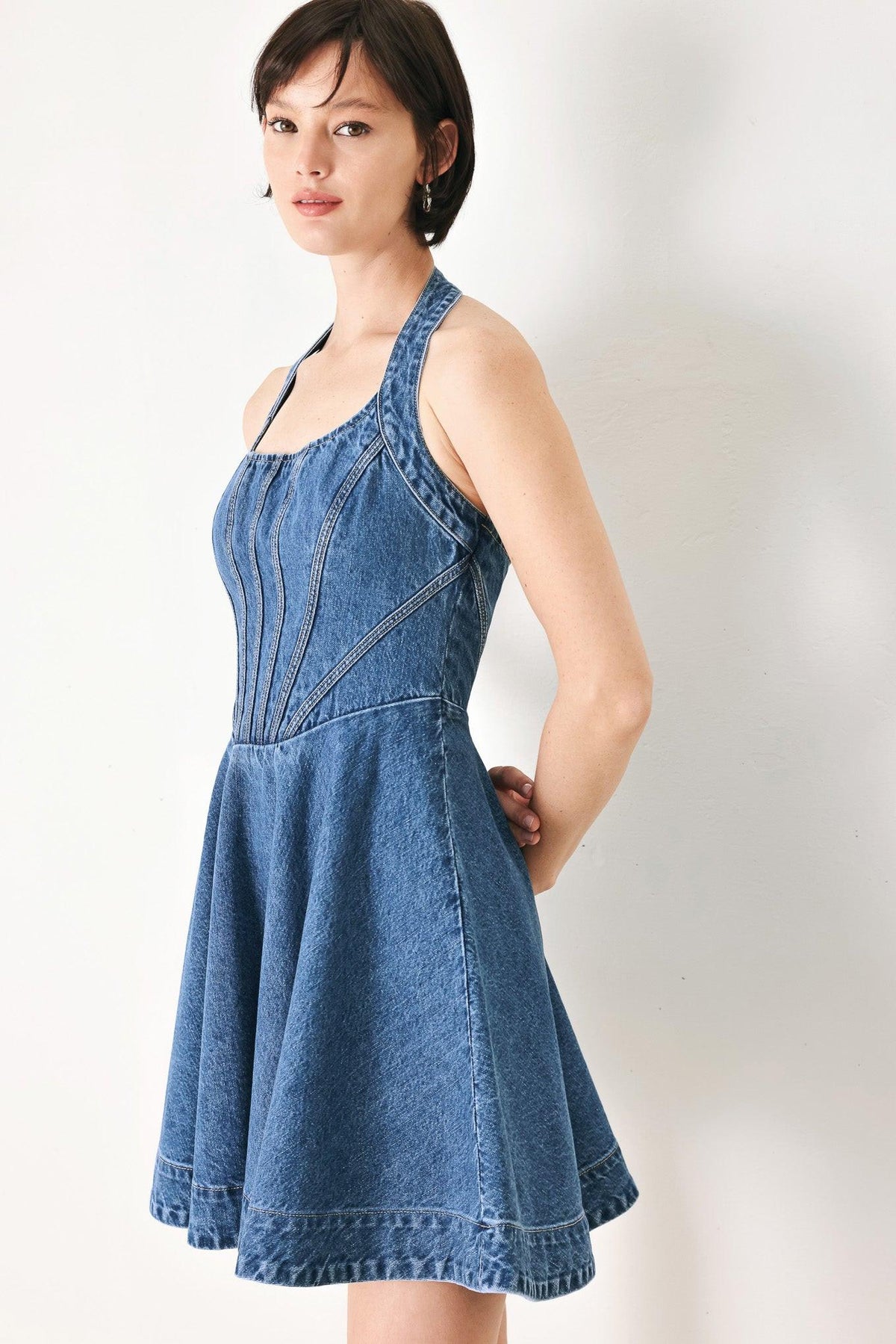 Flying Tomato vintage shape denim mini dress in indigo with a fitted waist and sleeveless design, displayed on a hanger.