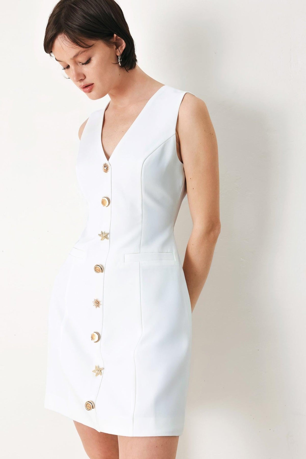 Off-white woven mini dress by Flying Tomato from the PURE GLAM collection, featuring a stylish, textured fabric and sleeveless design.