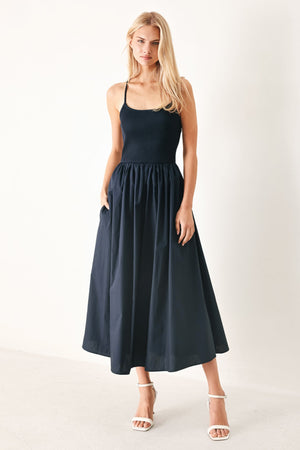 Flying Tomato Easy Breeze navy woven midi dress shown on a hanger with a flowy, lightweight fabric and sleeveless design.