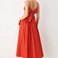 Flying Tomato Riviera Nights woven midi dress in coral red featuring a flowing, patterned fabric with a fitted waist and sleeveless design.
