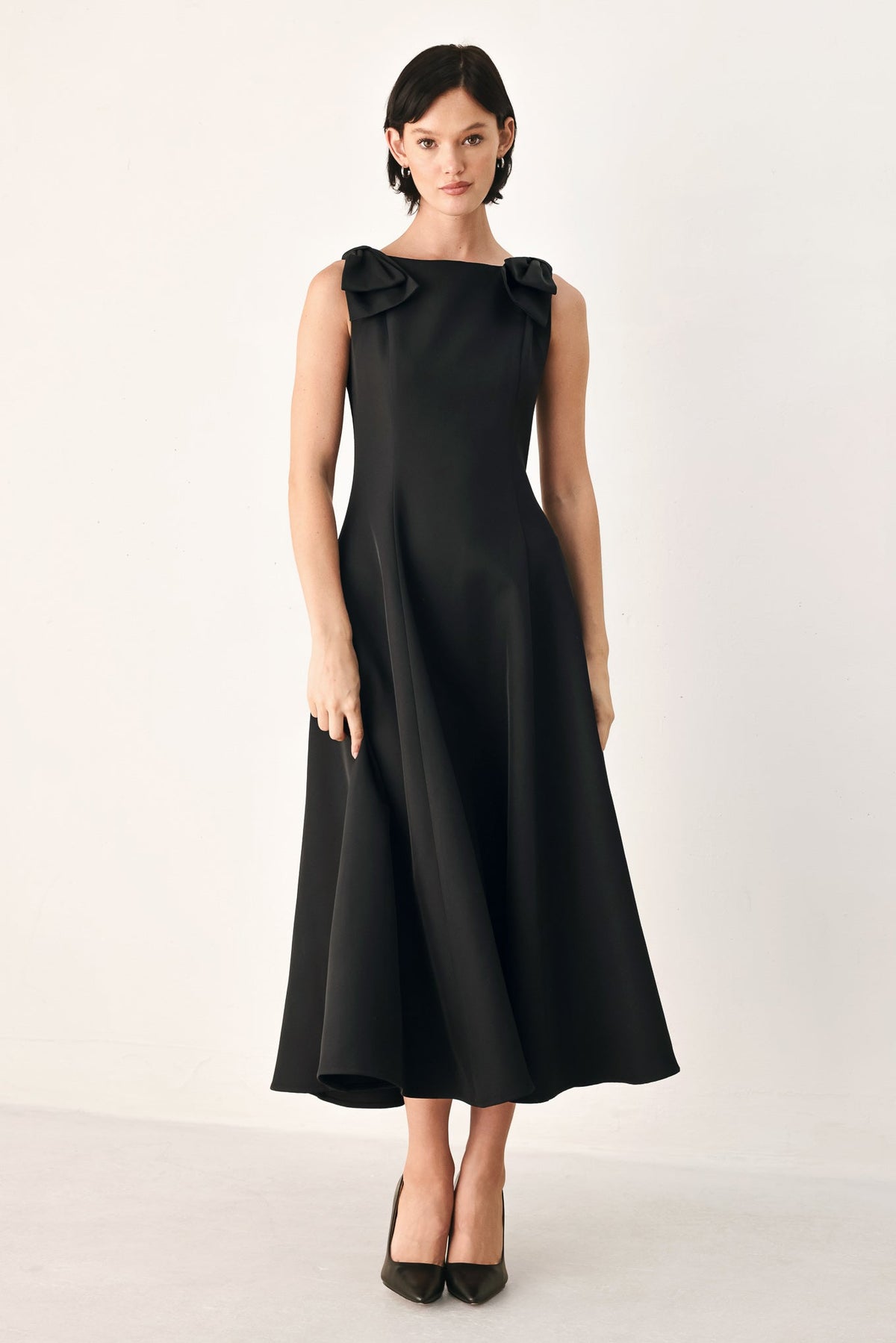 Black Tied to Tonight Bow Shoulder midi dress by Flying Tomato, featuring bow details on the shoulder and a sleek, midi-length silhouette.