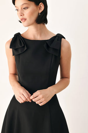 Black Bow Shoulder Midi Dress by Flying Tomato featuring a fitted silhouette and elegant bow details on the shoulders.