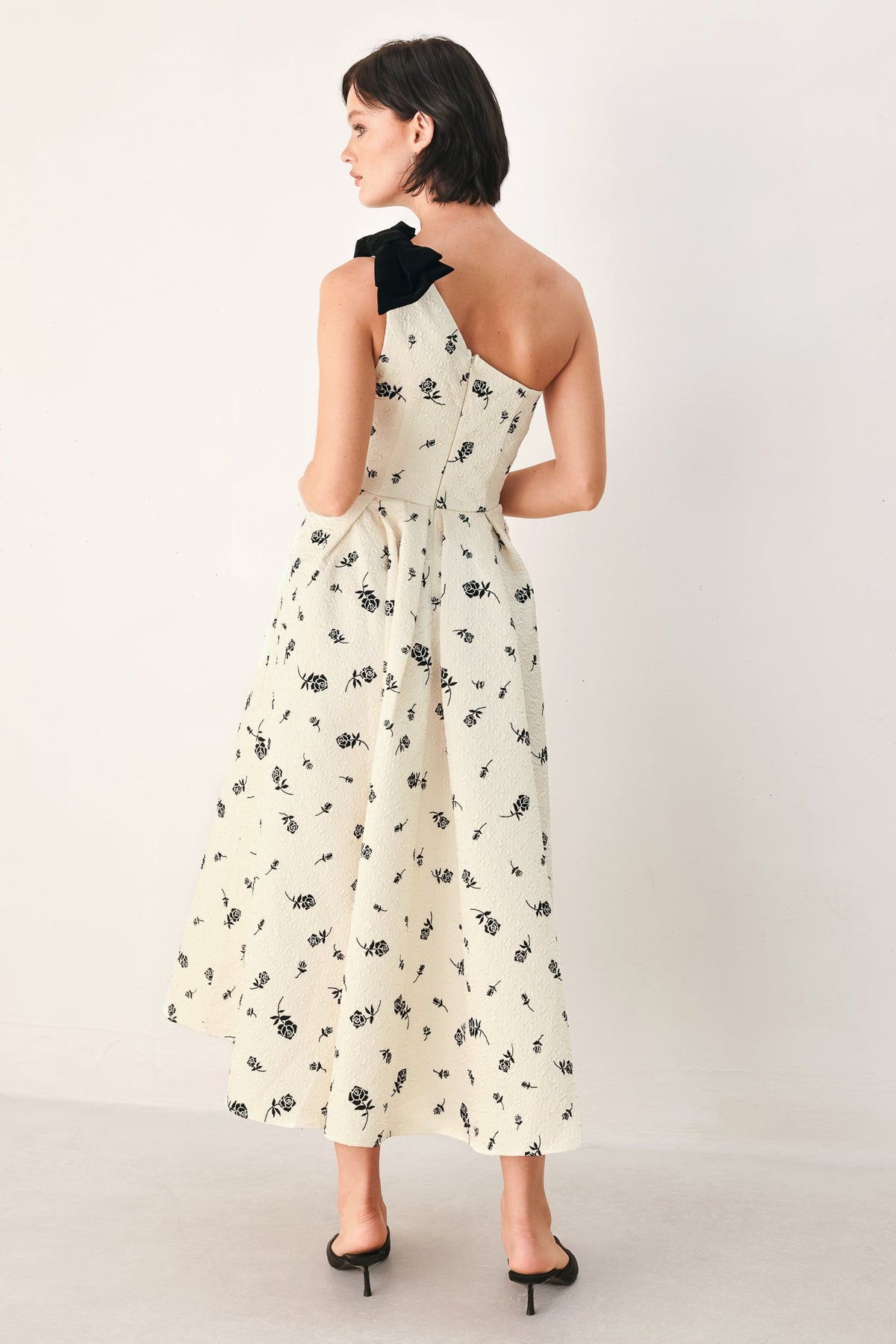 Cream and black one-shoulder bow midi dress from Flying Tomato featuring elegant design and fitted silhouette.