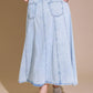 Light denim Urban Cowgirl midi skirt by Flying Tomato, featuring a classic denim design and midi length, shown on a model.
