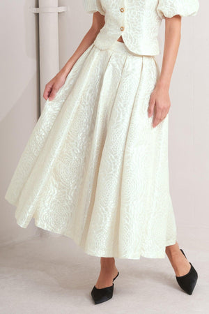 Cream-colored ROSÉ Texture Woven Full Midi Skirt by Flying Tomato, showcasing its detailed woven fabric and flowing silhouette.