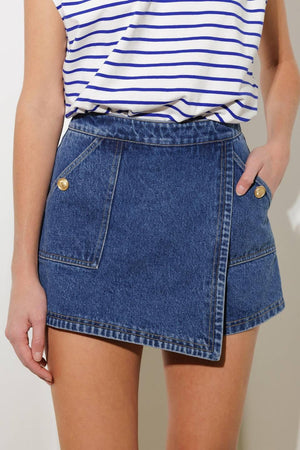 Flying Tomato denim skort shorts with a stylish, casual design, featuring a light blue denim fabric and front pockets.