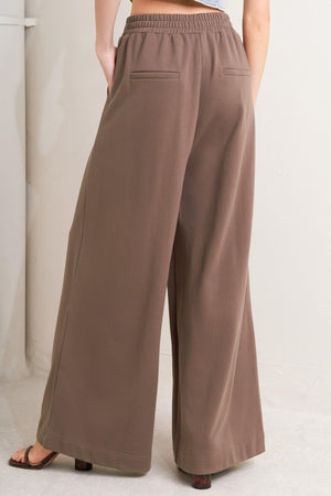 Brown Flying Tomato In Too Deep Knit Pants, cozy and stylish, shown on a model with a relaxed fit and comfortable knit fabric.