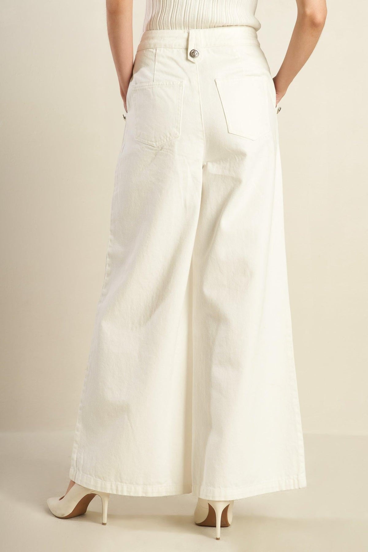 White woven pants by Flying Tomato featuring a delicate hue and relaxed fit, shown on a model.