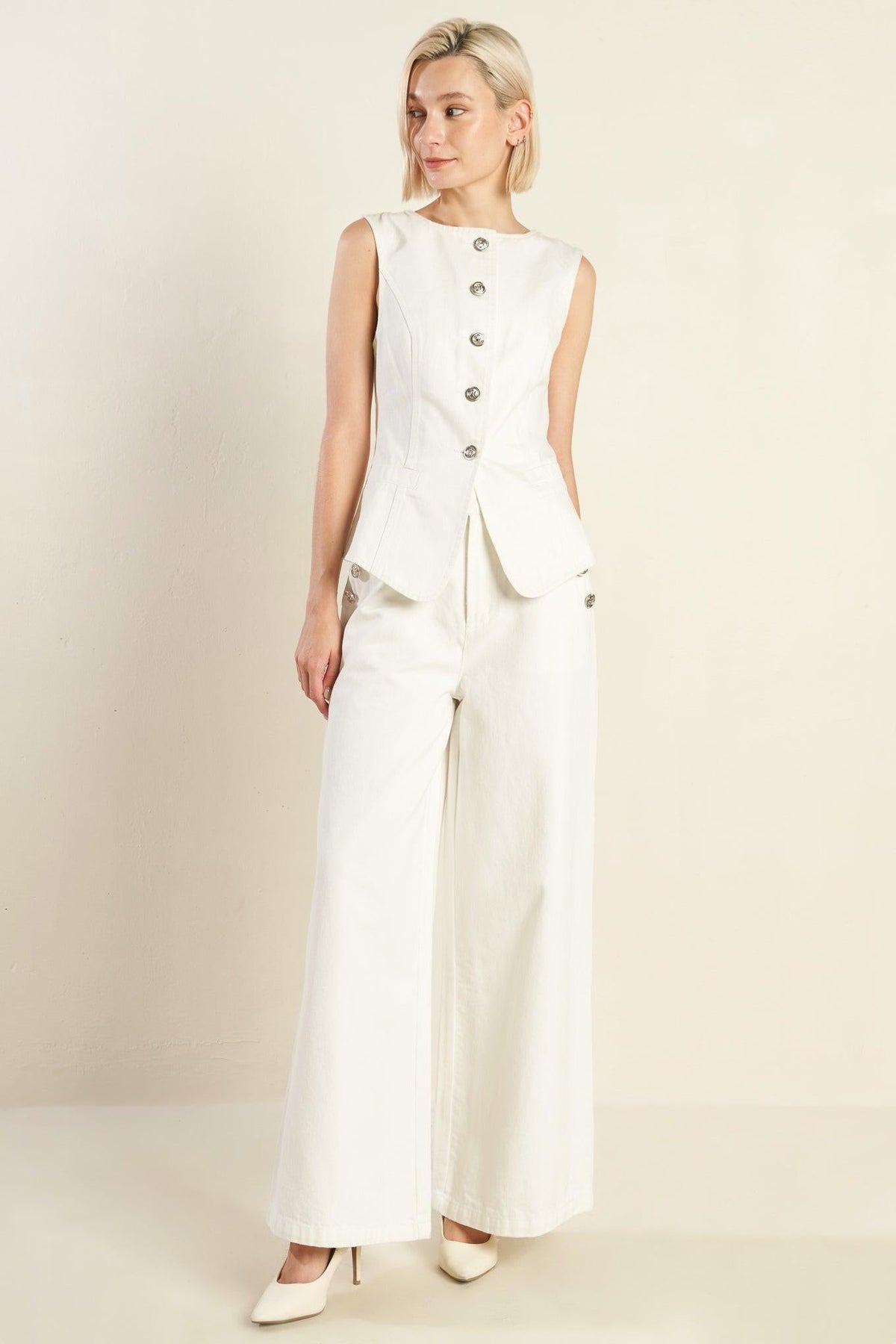 White Delicate Hue Woven Pants by Flying Tomato displayed on a hanger, showcasing their lightweight, textured fabric and relaxed fit.